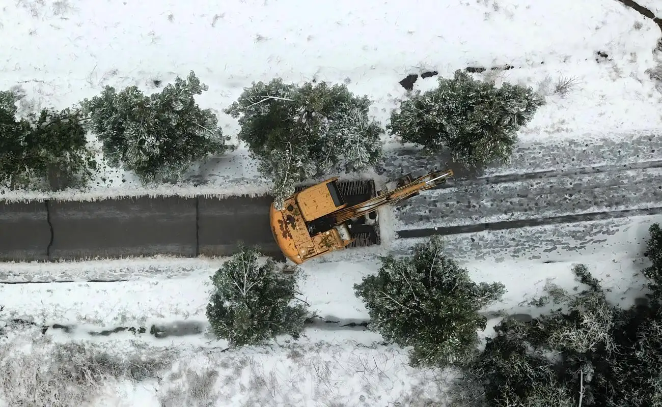 Excavator working in snowy weather